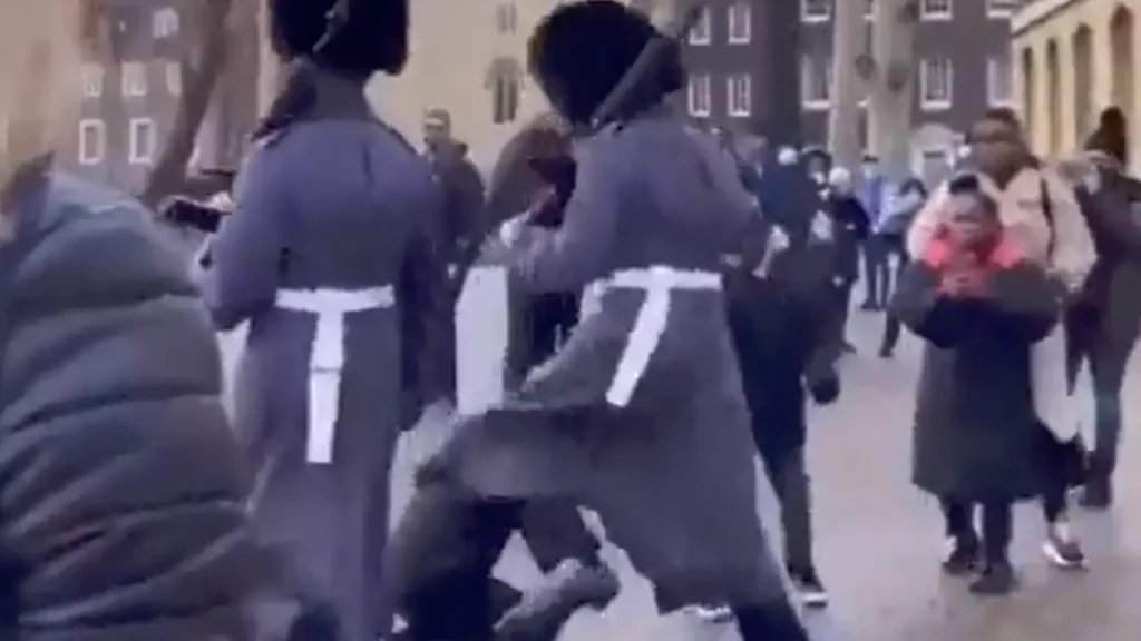 UK Queen's Royal Guard kicking down some poor kid brutally who was in the way during a march - Seriously WTF! NewsJive